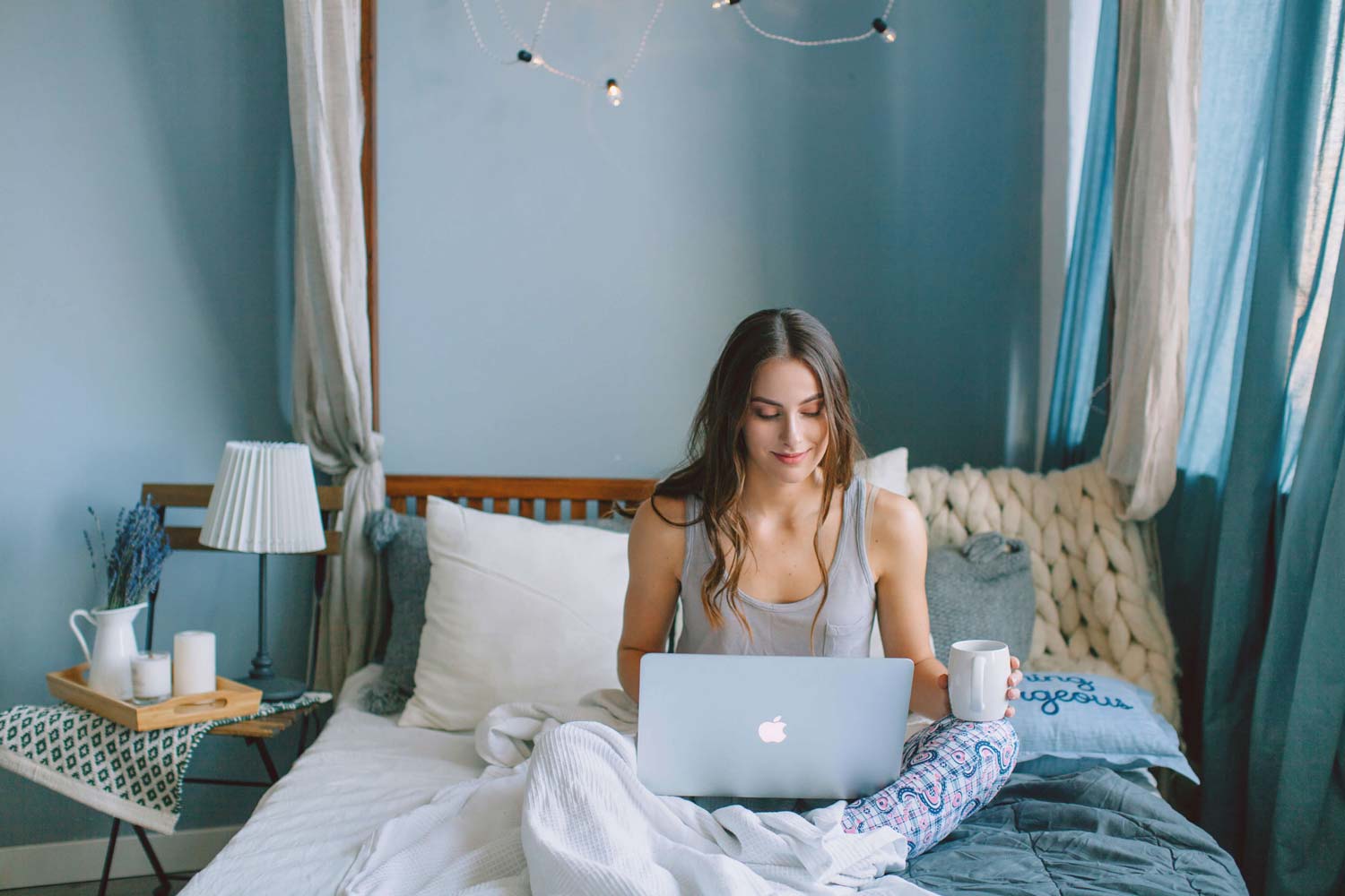 A young woman using No Code software with a laptop computer.