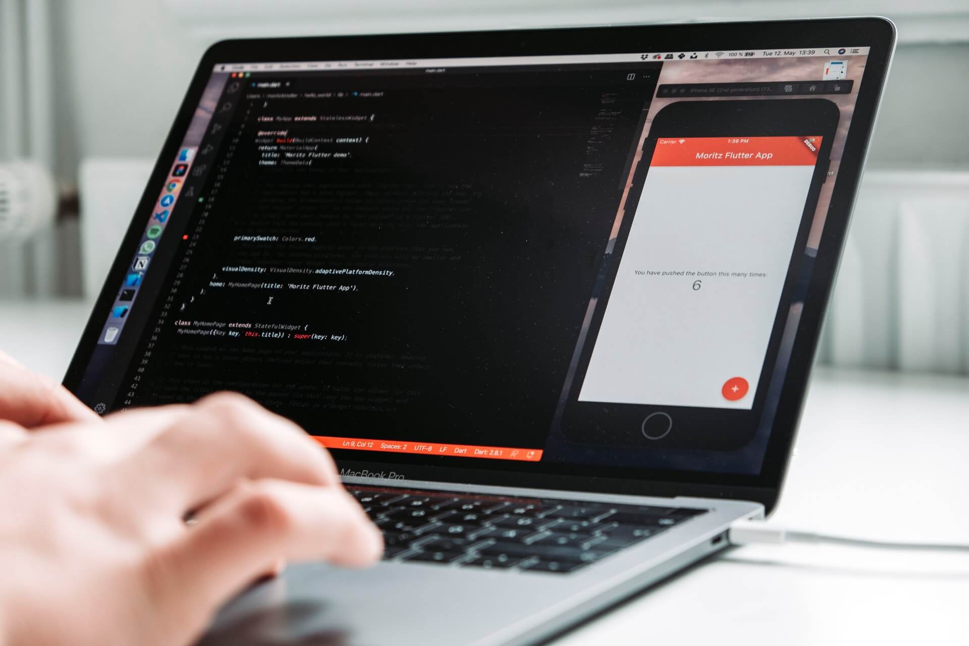 an outsourced software developer writing the code of a mobile app